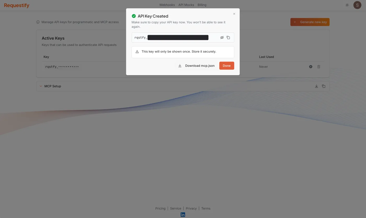 The dialog shown after generating a key: the key masked with show and copy buttons, a warning that it’s shown only once, and the Download mcp.json and Done buttons.